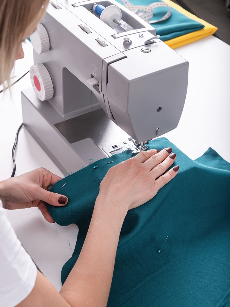 woman tailor sewing the textile in her studio